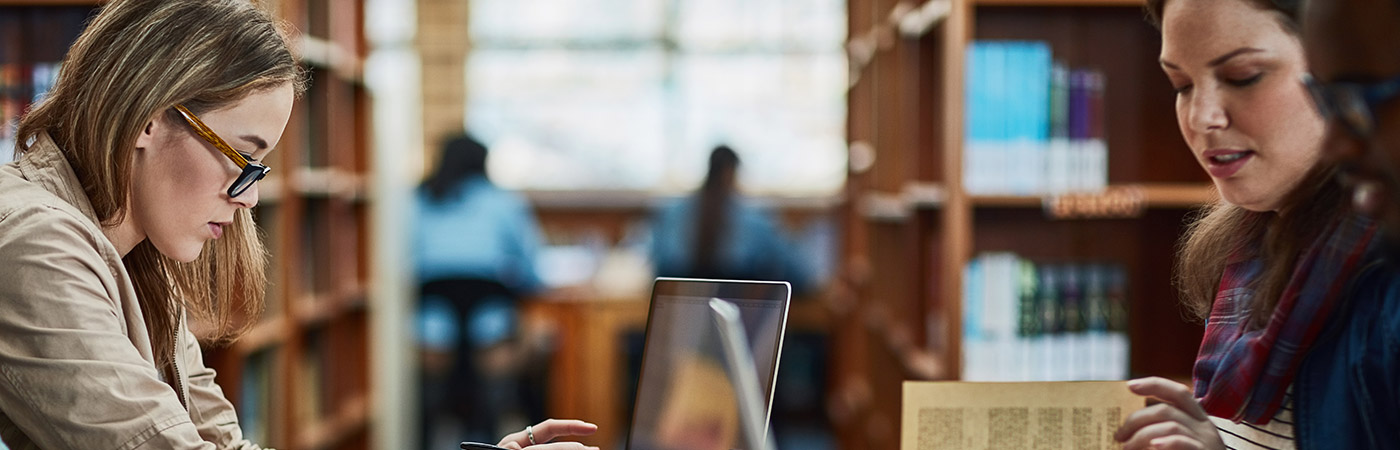 two people sitting at a desk working